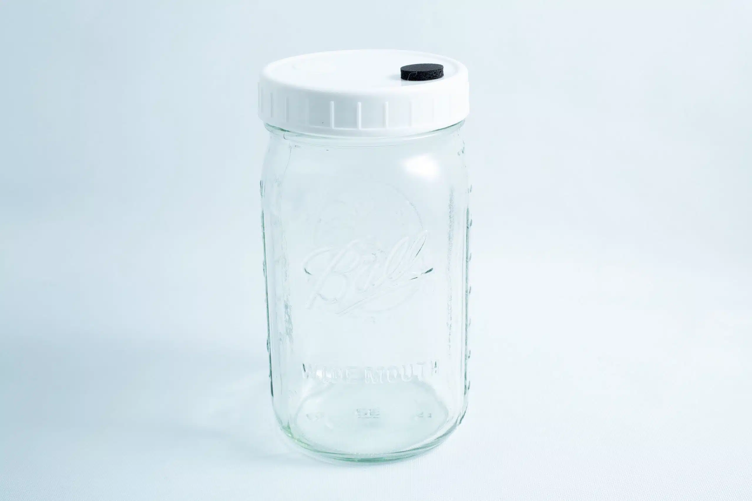 Mycology premade Wide Mouth Mason Jar Lids white with inj port and air filter 2 A 1 litre Ball wide mouth jar with injection port and air vent, featuring a white plastic lid, is placed upright on a white background. Genuine and autoclavable.