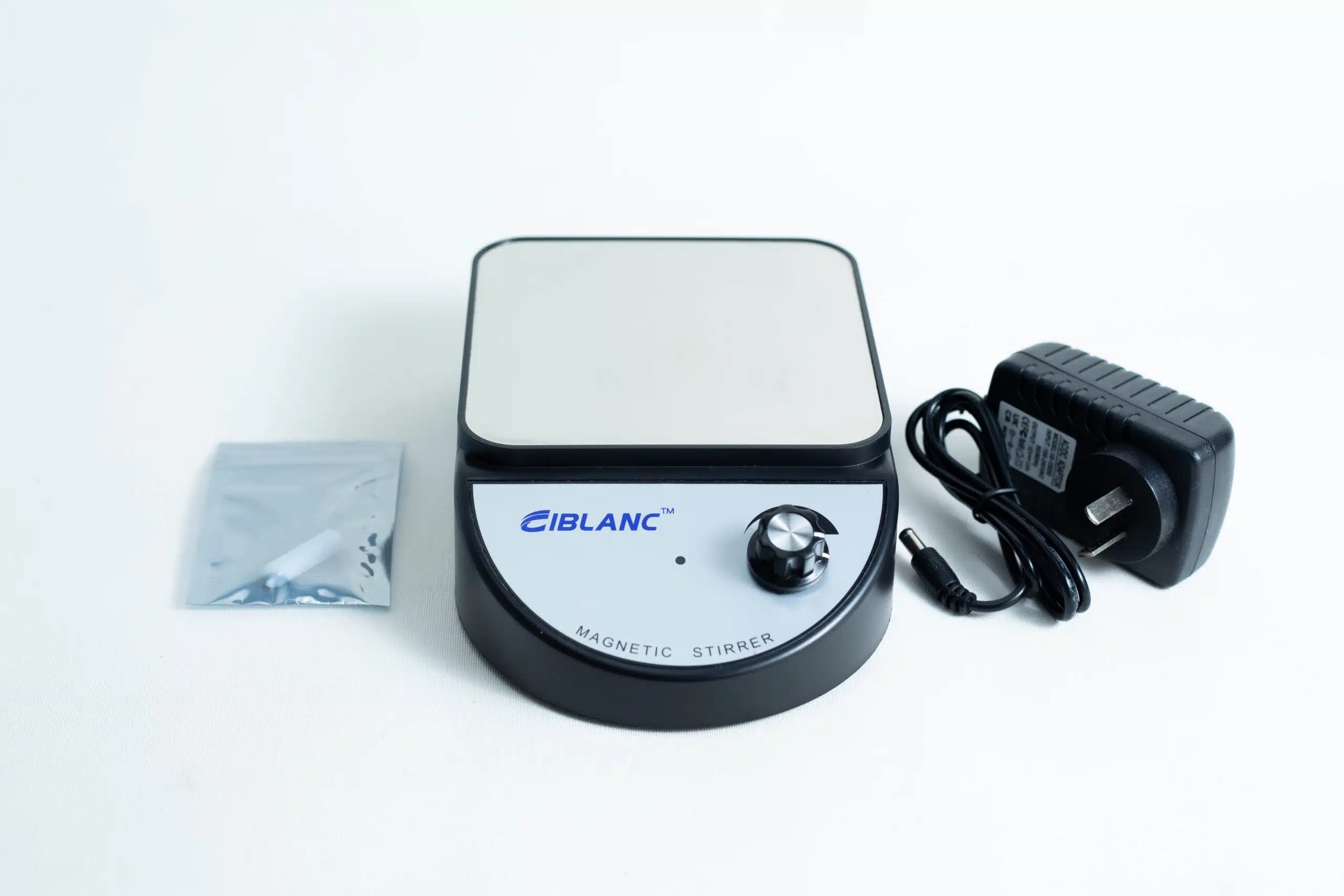 A Magnetic Stirrer Ciblanc 3500rpm (NZ plug) with a control knob, power adaptor, and small plastic bag is displayed on a white surface.