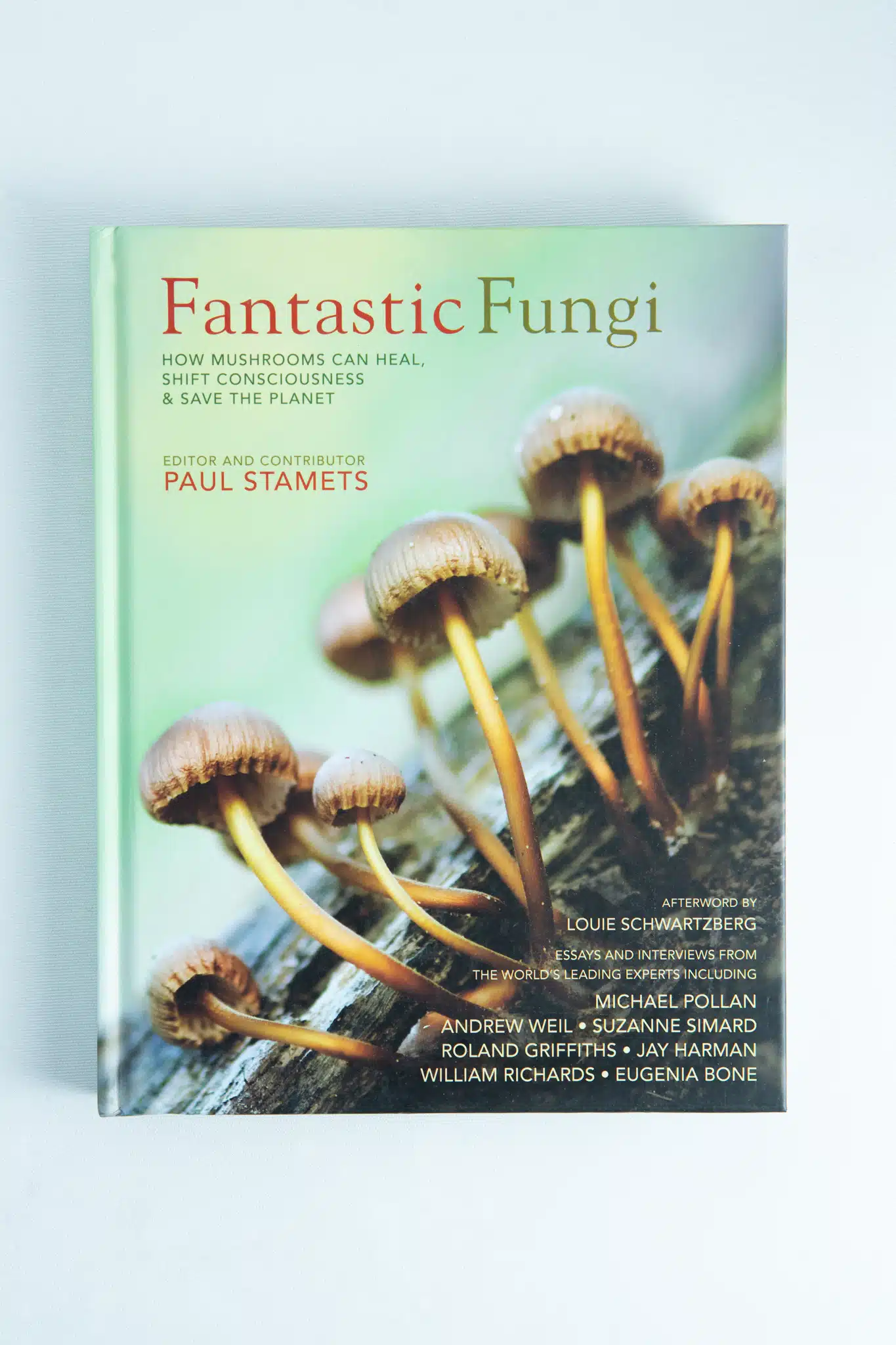 The book Fantastic Fungi by Louie Schwartzberg is shown, featuring a cover with brown mushrooms on a log and the subtitle: How mushrooms can heal, shift consciousness & save the planet.