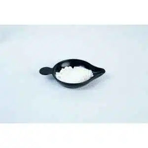 A small black dish with Antibacterial Powder for mushroom cultivation, a white granular or powdery substance, is placed on a plain white surface.