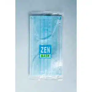 A Disposable Face Mask/Unit Individually wrapped is sealed in clear plastic packaging labelled ZEN MASK in blue and green, and placed on a light grey surface.