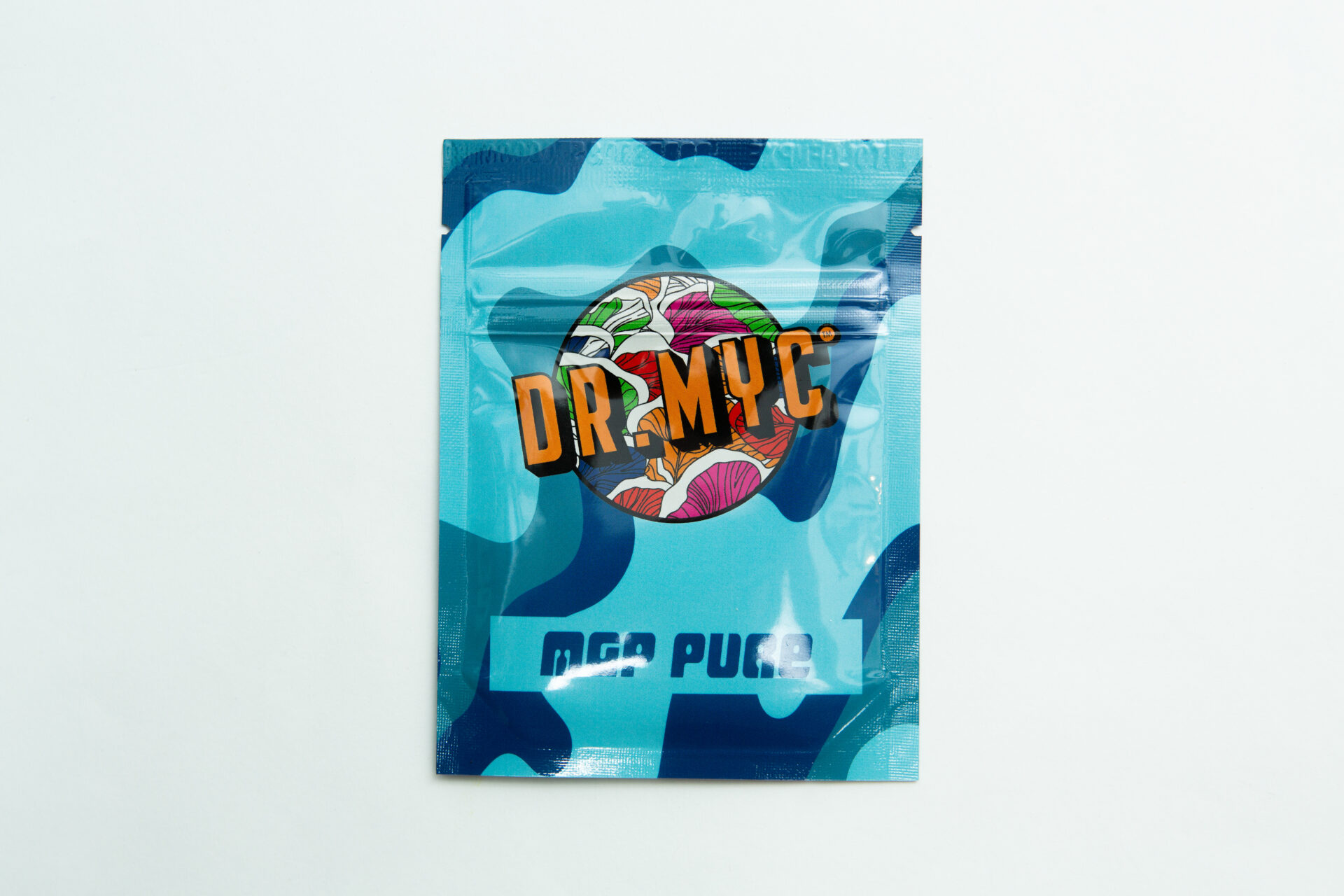 DRMyc MGP Pure - Gourmet/Medicinal Mushroom Growth Promoter 1 A blue resealable pouch labelled DRMyc Adaptive Liquid Culture Premix, with a vibrant mushroom illustration and "MGA PUGA" below, is shown on a plain white background—ideal for liquid culture enthusiasts.