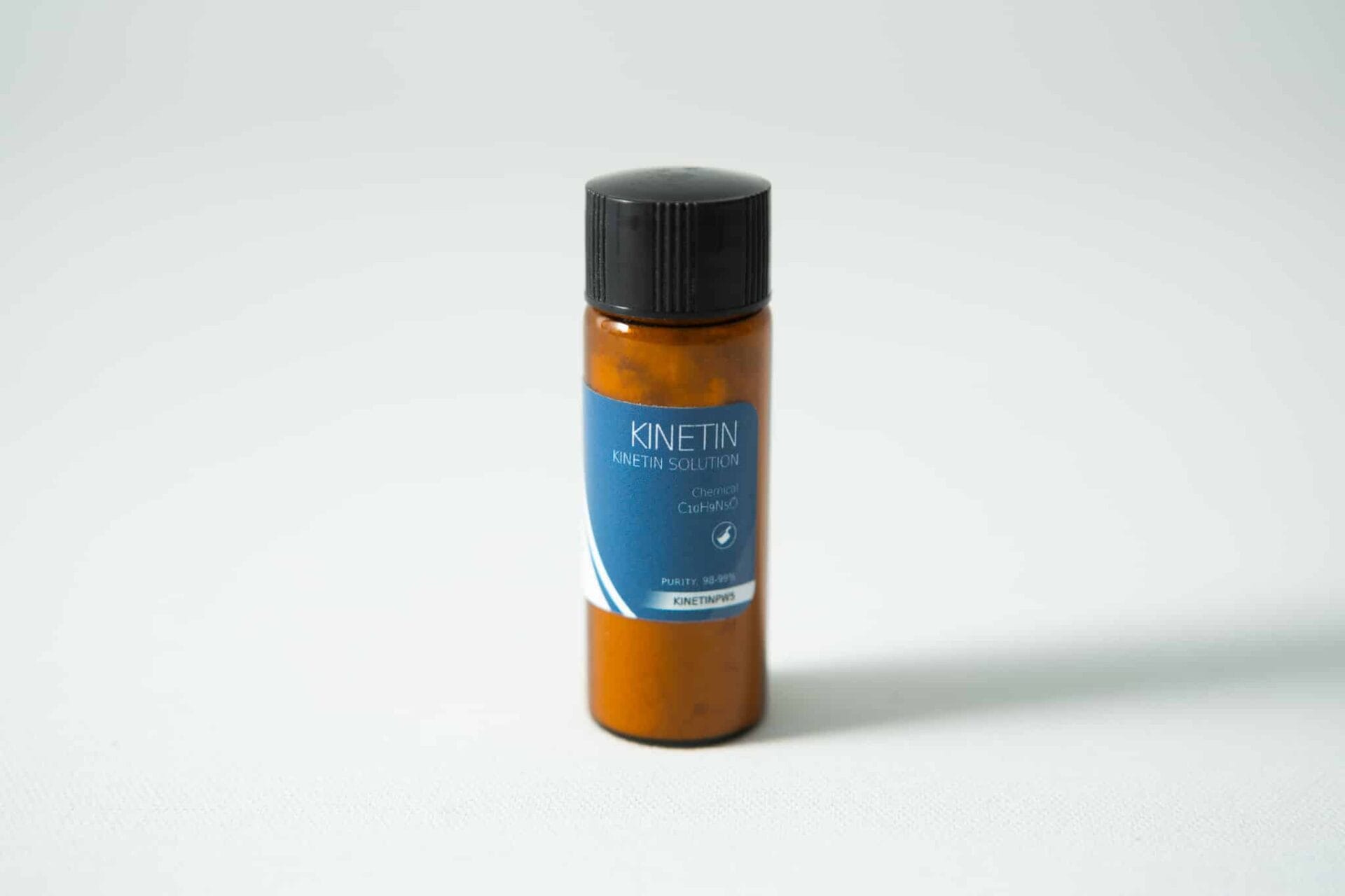Plant Cell Kinetin Powder 1 A small brown plastic bottle with a black cap and a blue label reading “Plant Cell Kinetin Powder” stands upright on a plain white surface. This plant hormone is derived from kinetin powder.