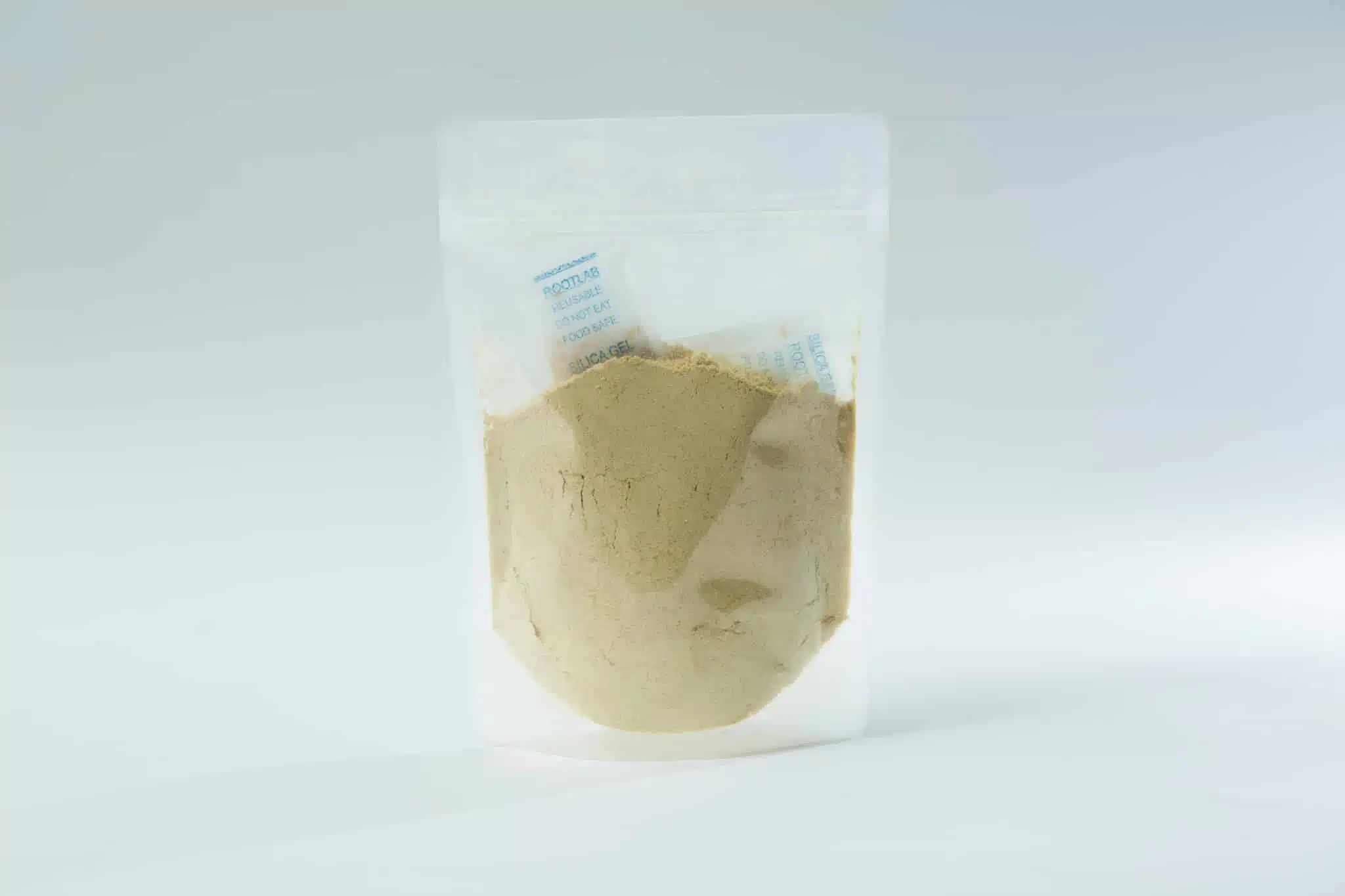 Australian grown Freeze Dried Lions Mane Mushroom (Powder) 1 A clear resealable plastic pouch filled with light-coloured powder, containing visible moisture absorber sachets, placed against a plain white background.