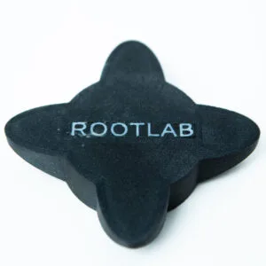 A black, four-lobed object with the word ROOTLAB printed in white capital letters on its surface, placed on a plain white background.