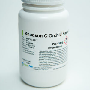 A white plastic container labelled Knudson C Orchid Basal, with warnings including Hygroscopic. The container displays product and batch information, manufacturer details, and instructions in small text.