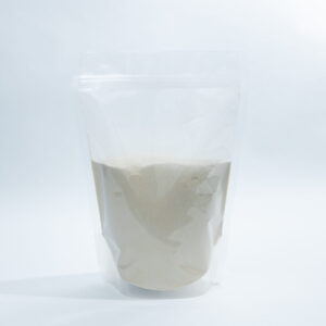 Home 11 A clear, resealable plastic pouch filled with a light beige powder stands upright against a plain white background.