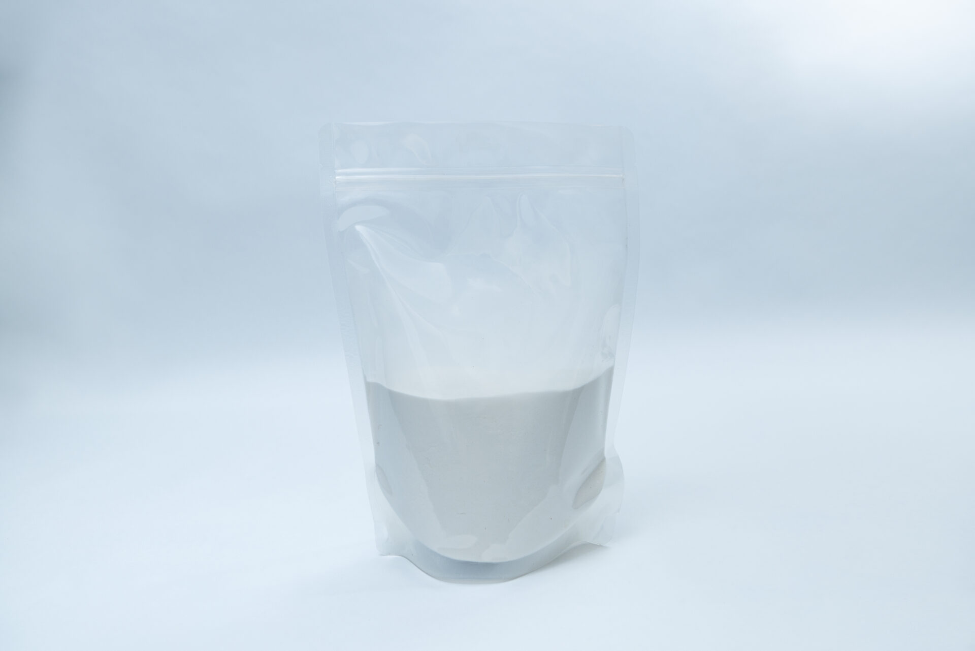 Gellan Gum Low Acyl 1 A clear, resealable plastic bag filled halfway with a fine white powder, standing upright against a plain, light background.