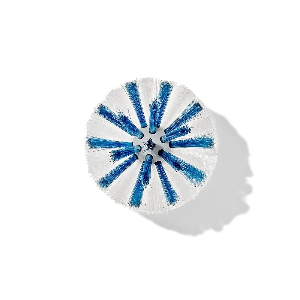 OXO Good Grips Bottle Brush replacement heads, 2 pack 2 Top-down view of a round brush head with white and blue bristles, arranged in a circular pattern and casting a shadow to the right on a plain white background.