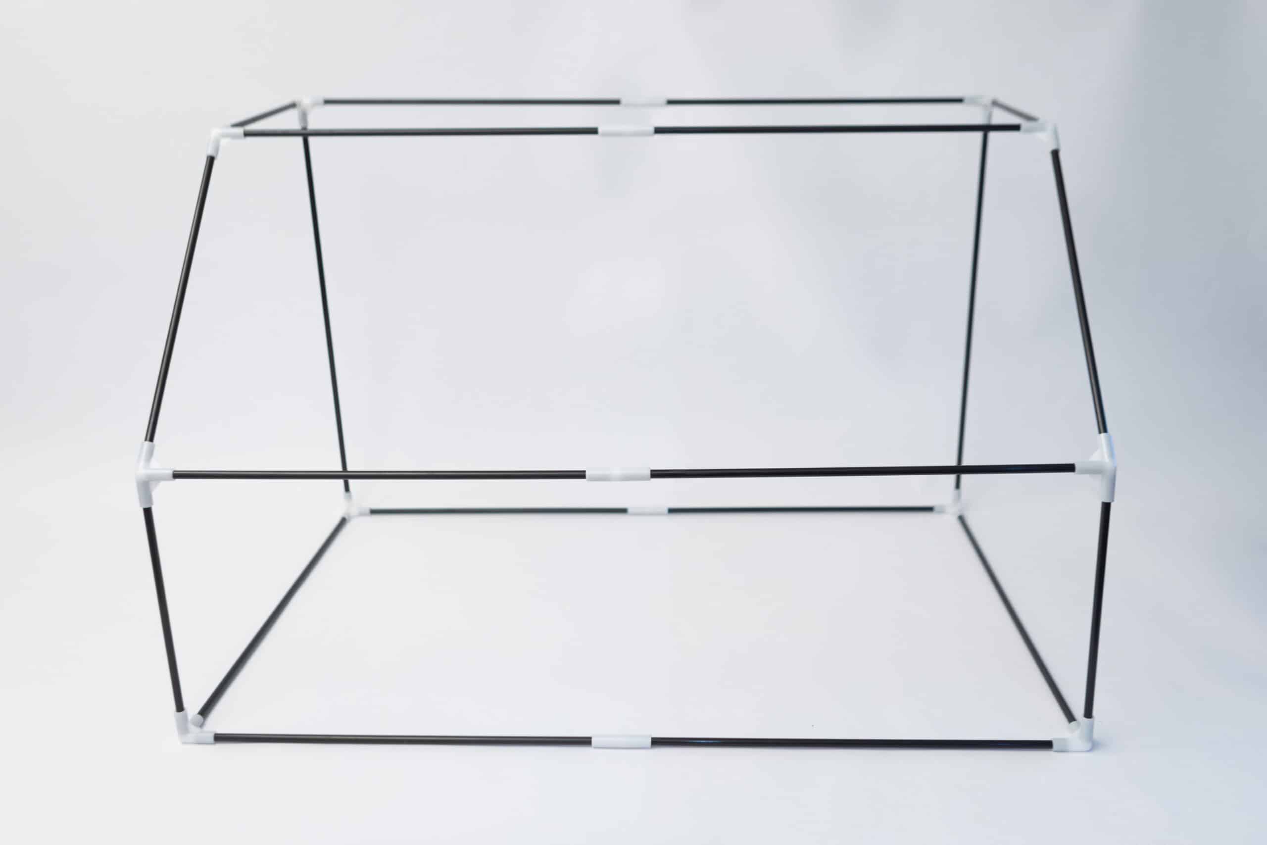 Rootlab Still Air Box with angled viewing window- XL 7 A simple black and white geometric frame structure made from thin rods connected at the corners, forming a rectangular shape, set against a plain white background.