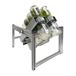 Home 10 The Plant Cell BioTilt™ 8 features a metal frame with four legs, inspired by the BioTilt 8 design, supporting six glass jars filled with plants. Each jar is angled downward to emulate a Plant Cell environment and is secured by grey brackets. The product is shown against a plain white background.
