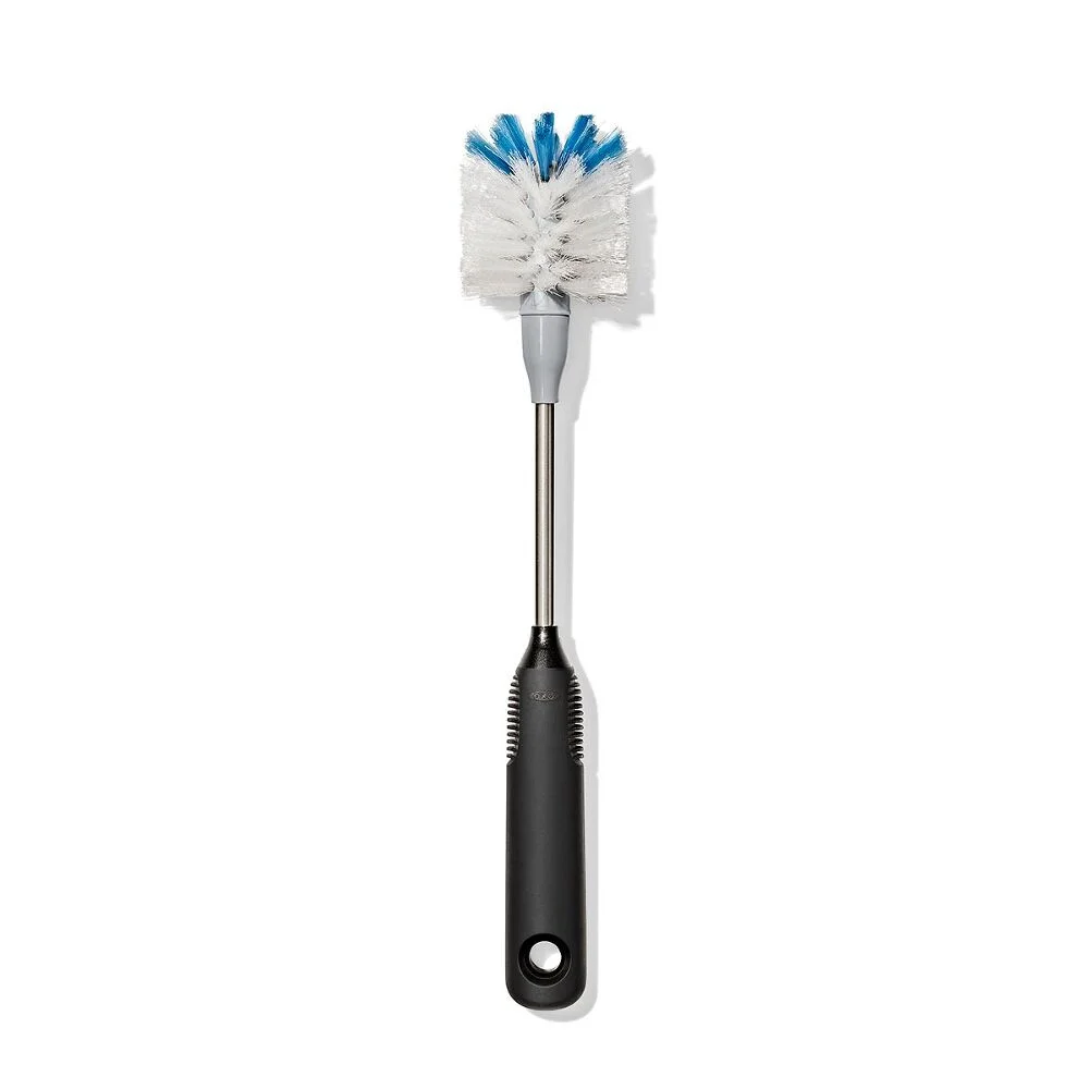 OXO Good Grip Stainless Steel Bottle Brush with replaceable head 1 A bottle brush with a black handle, a metal shaft, and white bristles tipped with blue, photographed on a white background.